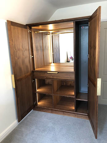 Walnut wardrobe interior with mirror and concealed lighting, handmade in Shropshire